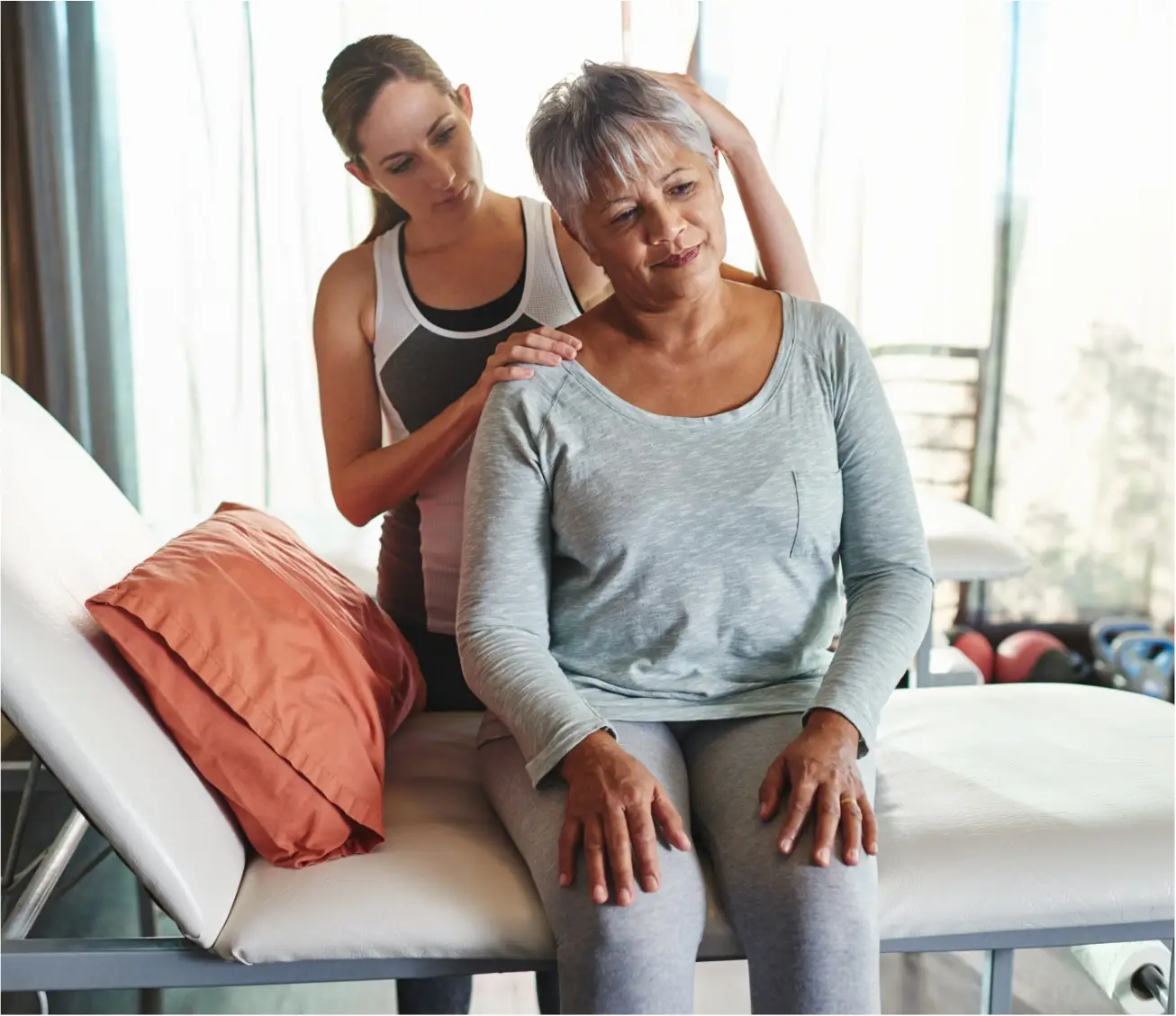 Specialist providing physiotherapy support to a woman.